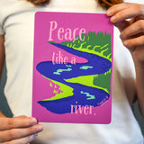 Person holding a card with a colorful design and text 'Peace like a river' on a pink background.