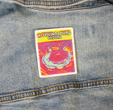 A colorful patch with the text 'Horseshoe Bend Arizona' displayed on the back of a denim jacket.