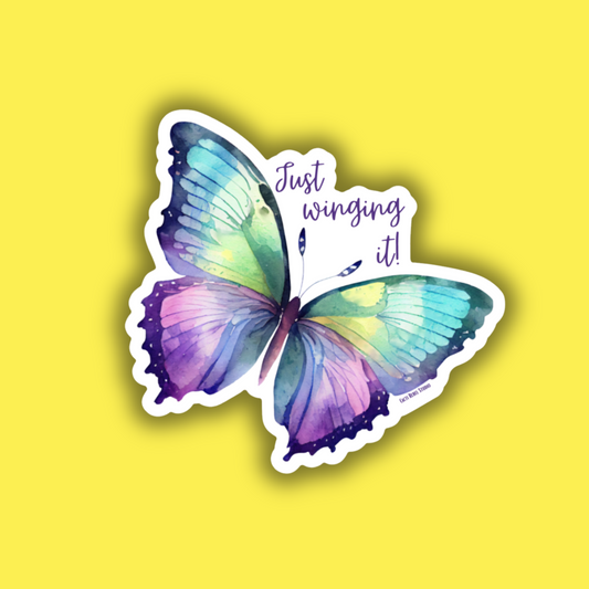 Colorful butterfly sticker with 'Just winging it!' text on a yellow background