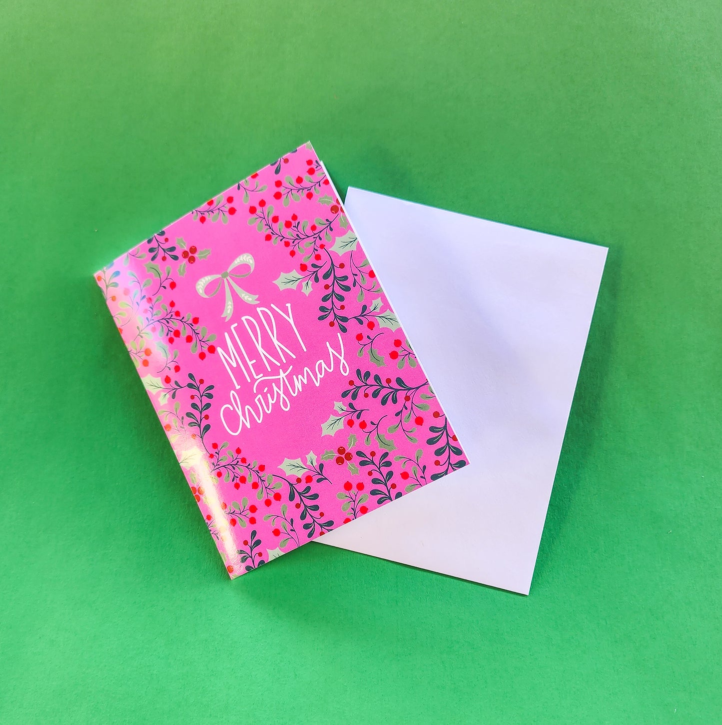 Pink Merry Christmas Greeting Card with Decorative Holly