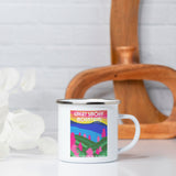 White mug with colorful 'Great Smoky Mountains' design on a white surface with a wooden vase in the background.
