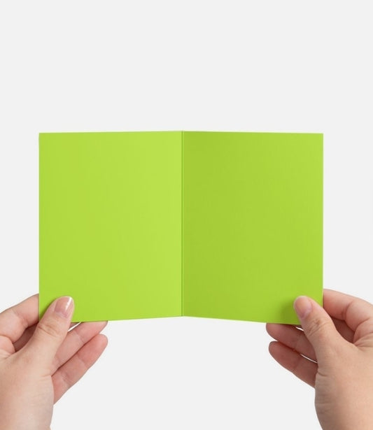 Green card held between two hands on a white background